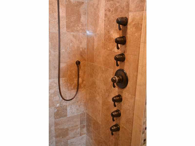 Water Feature Wall in a Travertine Shower - JW Construction & Design Studio Services